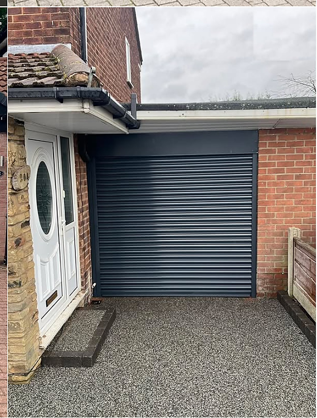 Anthracite roller garage door fitted to a brick house by Wilks