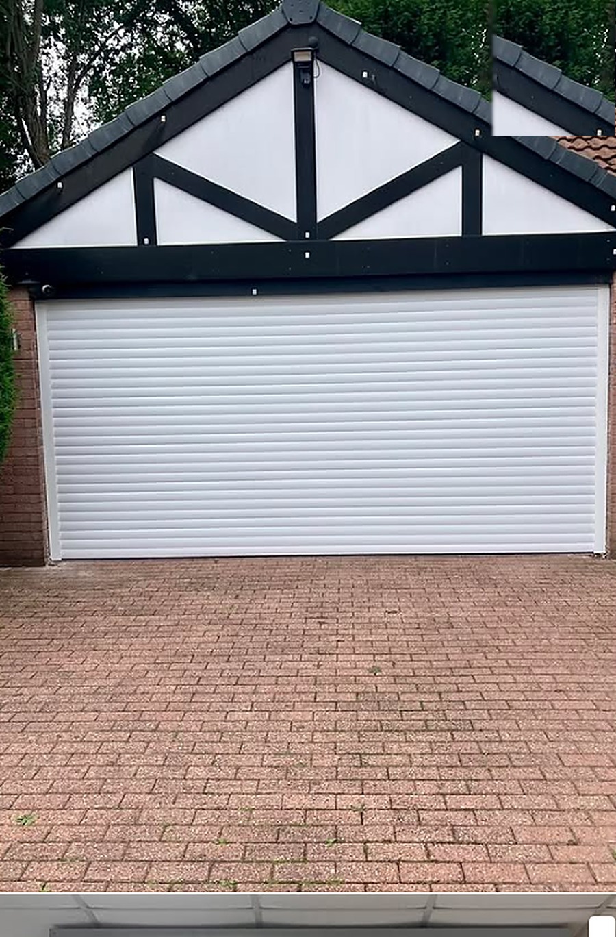 White double roller garage door installed by Wilks